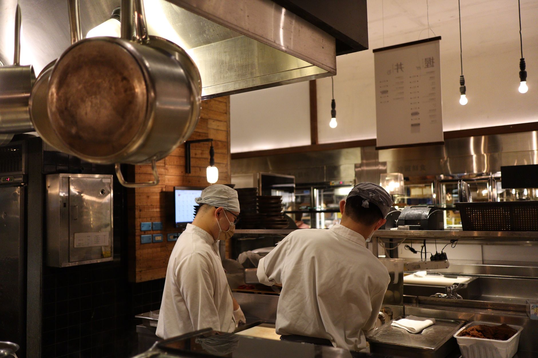 Chef plating food in a busy professional restaurant kitchen serving the HORECA channel