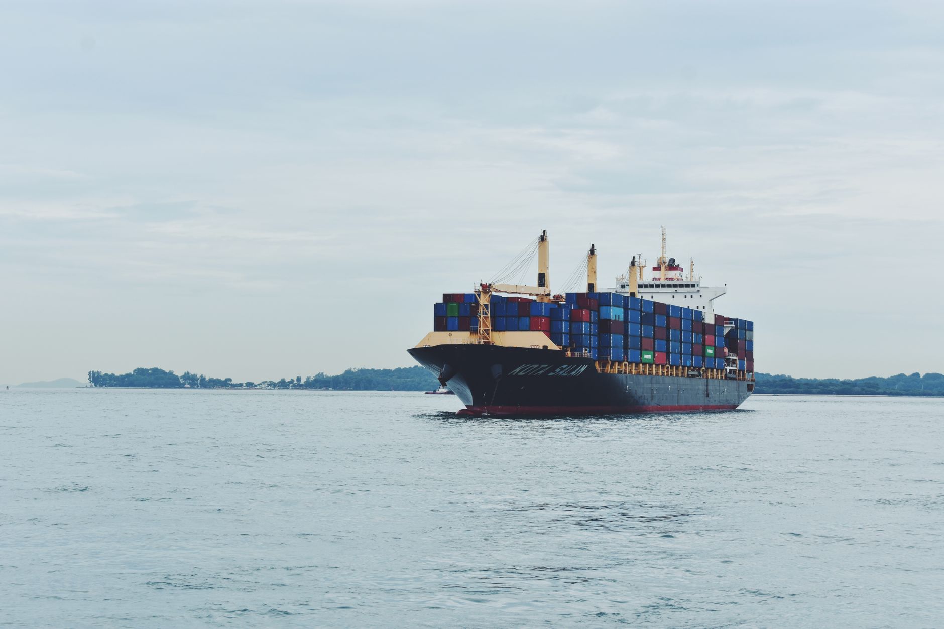 Refrigerated shipping containers being loaded onto a cargo vessel for frozen pork export