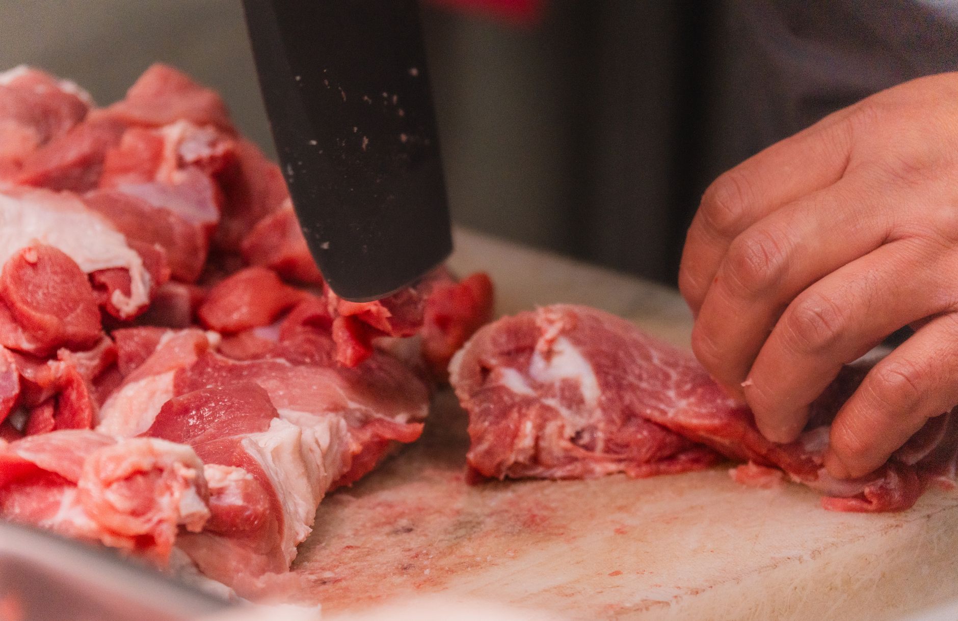 Veterinary inspector reviewing pork carcasses at a SIF-approved processing plant